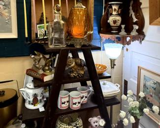 Wood shelving, brass birds, lamp, kitchenware art and carnival glass.