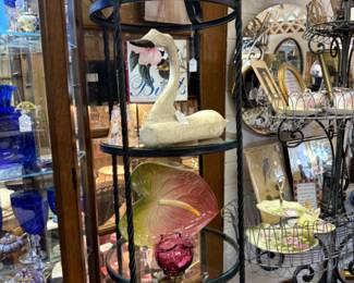 Carved swan, iron & glass shelving , blue glass, Royal Albert dishes.