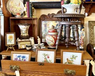 Short Mid Century chest of drawers, bird and flower art, vintage swivel chair, wood carved mirror with detailed frame.