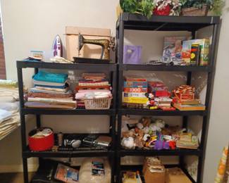 Old singer sewing machine (antique), sewing supplies including material, typewriter, kids' games and stuffed animals, odds and ends.