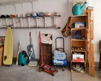 16-foot aluminum ladder, 6-foot wooden ladder, many ball hats, creeper, 2 sweepers, ironing board, paint supplies, air compressor, many other tools.