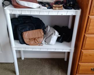 Purses, and wallets, etc. White plastic shelve is for sale.