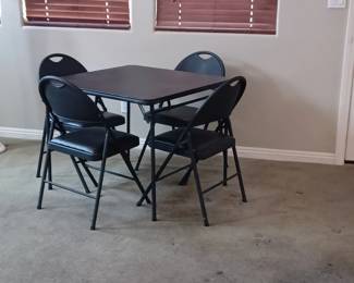 Black card table with 4 matching chairs.