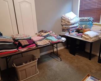 Quilts (some brand new), sheets, blankets, pillowcases, shower curtain with hangers, table clothes, curtains, and women's clothes - jeans, dress pants, shorts, skorts, skirts, dress tops both long and short sleeves, swimsuit.