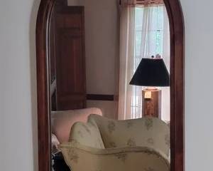 Antique arch framed mirror with walnut carved frame