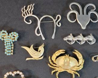 Collection of sterling and costume pins and brooches
