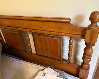 Closer look at headboard for queen-size bed with mattress and box spring.