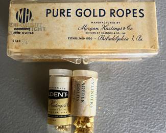 Vintage dentistry items including partial containers of pure gold ropes and cylinders.