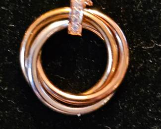 Close-up of Cartier Trinity necklace.