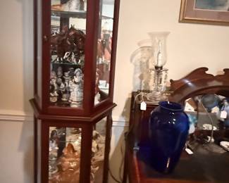 One of a pair of curio cabinets