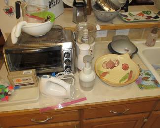 We have a great kitchen full of goodies! Small appliances include Mr Coffee, Oster, and a Crock Pot. Corningware, bakeware, serving platters, cookware, kitchen utensils, knives, dinnerware, glassware, and more.