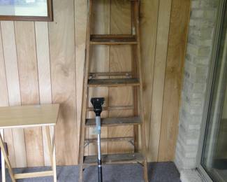 Another folding table, wooden ladder, and ice scraper