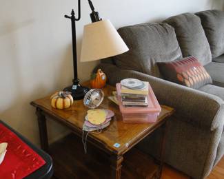 From the top, we have a lamp, some nice collectibles, books and a table too