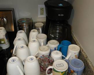 These are coffee cups, and the coffee maker is shy and hanging out in the back