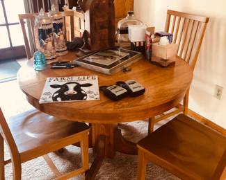 Round dining room table with four chairs