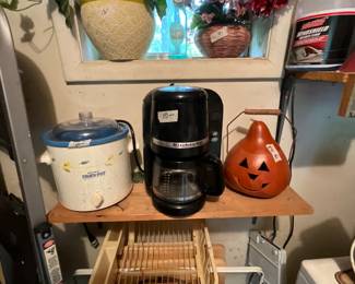 Outside laundry room with storage  -crock pot, kitchen-aide coffee maker, pumpkin, TV trays