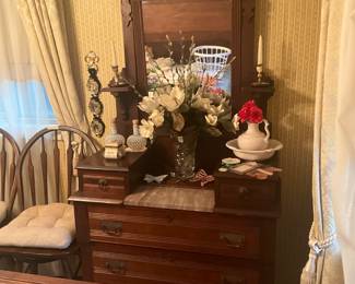 Antique dresser with insert & 3 large drawers.  Decor includes 2 Fenton hobnail perfume bottles, candle sticks, flower arrangement in lovely glass jar,  white jar with basin set