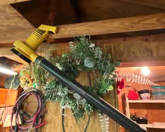 Outside storage building in back yard - Blower, wreath and more