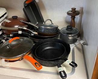 Kitchen - on stove - iron skillet, orange Teflon skillet with lid, and more
