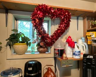 Outside laundry room with storage - clen(ng products, plant - decorative heart