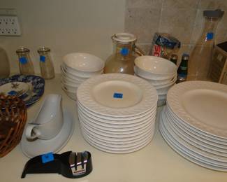 Plain white dishes, salad plates, soup bowls and dinner plates, all set a perfect table