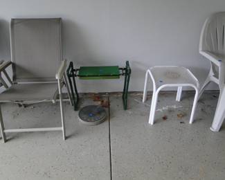Some great patio furniture, garden items, a sundial, and leaves on the garage floor