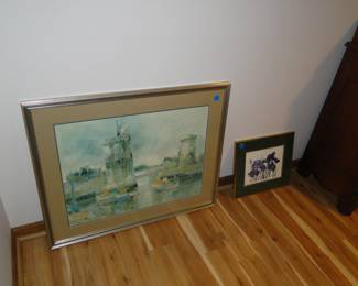 Framed artwork, sitting on the floor, probably better off on the wall too