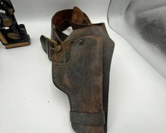 This is a fun lot for gun collectors. There is a vintage Police Officer belt with holster, a second holster, an NRA belt - 43” to the first hole, tooled leather belt is adjustable. We included a couple of fun vintage bookends/chess figure to round out the collection.
See items descriptions and photos for condition details.