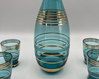 Includes a teal glass decanter with gold accents and six matching shot glasses. The set is styled in a classic 1970s design. Perfect for collectors or special occasions. Included in this set is four gold chargers made of plastic/resin.
See items descriptions and photos for condition details.