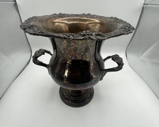 An elegantly designed vintage urn featuring intricate grapevine motifs on the rim and handles. This exquisite piece is crafted from silver-plated material, showcasing a rich patina. Estimated to date from the early 20th century, this urn is perfect for collectors or as a decorative centerpiece.
See items descriptions and photos for condition details.