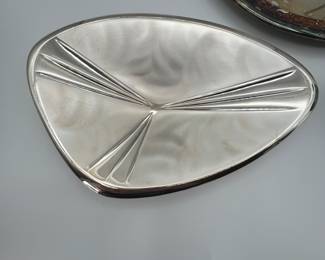 This auction lot features a vintage Taunton silver plate serving set from the 1970s, including a unique triangular serving tray and a cup. The serving tray showcases beautiful design details, while the cup boasts a classic shape, perfect for any collection or dining experience. Ideal for collectors and enthusiasts alike.
See items descriptions and photos for condition details.