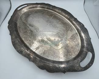 Oval silver-plated serving tray with ornate design and handles. Some wear and patina evident. Approximate dimensions: 22 inches in length.
See items descriptions and photos for condition details.