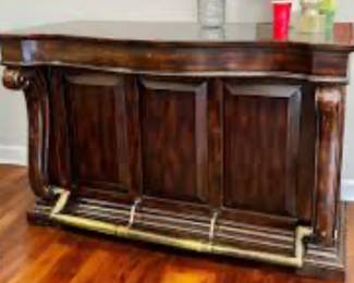 Artistica Bar Cabinet with brass footrest, storage drawers, wine and stemware racks, and top is inset with moisture resistant solid black marble. Constructed of Alder Solids and Cherry Veneers