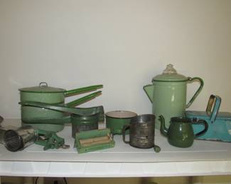 Several pieces of green granite and green handle kitchen utensils