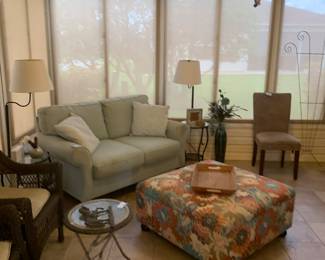 Comfy loveseat couch, colorful ottoman, literal table lamps!