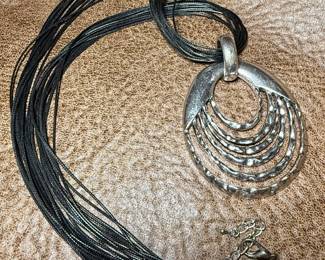 Silver medallion on leather chain