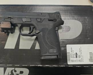 Smtih & Wesson M&P 40c with red dot laser.