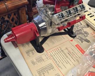 The visible V8 engine and paperwork