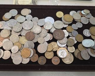 large pile of foreign coins selling them all for one money may contain some silver ?