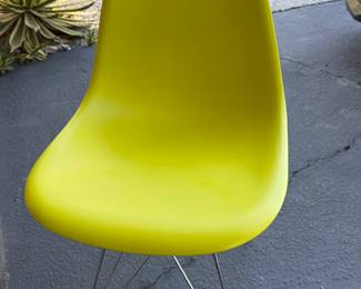 Set of 4 mcm Eiffel chairs, 2 yellow with metal legs, 1 yellow with wood legs, and one grey chair with wood legs.