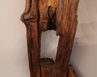 cathedral chair made from old fence post and wagon wheel