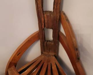 cathedral chair made from old fence post and wagon wheel