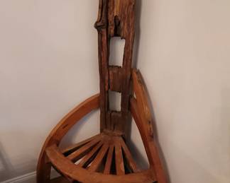 cathedral chair made from old fence post and wagon wheel