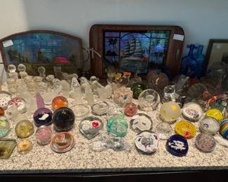 Glass paperweight collection including Fenton, Murano and Baccarat pieces.