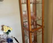 Solid oak lighted curio cabinet with 4 adjustable glass shelves inside, mirrored back and base and glass doors. Dimensions: 19.5W x 15.5D x 6'H; $98