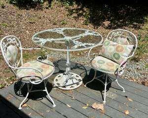 Vintage wrought iron patio set includes glass top table and 2 swivel chairs with cushions. $150