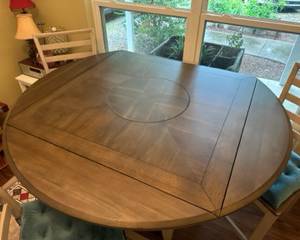 42" square high top table converts to 59" round with leaves, 18" Lazy Susan in the middle and 1 storage drawer below. Comes with 4 (24"H) chairs. $450