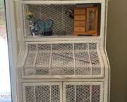 Vintage 1980’s white wicker bookcase with enclosed storage; top door hinges to open; bottom two doors open to more shelving. Super cute vintage piece! Measures 30.5” w x 17.5” d x 6’ h $150