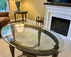 Wrought iron oval coffee table with beveled tempered glass top, brushed pewter finish, Dimensions: 50"long x 32"wide x 19.75"high, $175