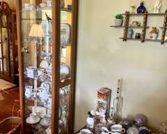 SOLD! Solid oak curio cabinet with mirrored back and bottom, glass side doors, 5 glass shelves; Dimensions: 24"wide at top, 21"W x 10.75"D $100